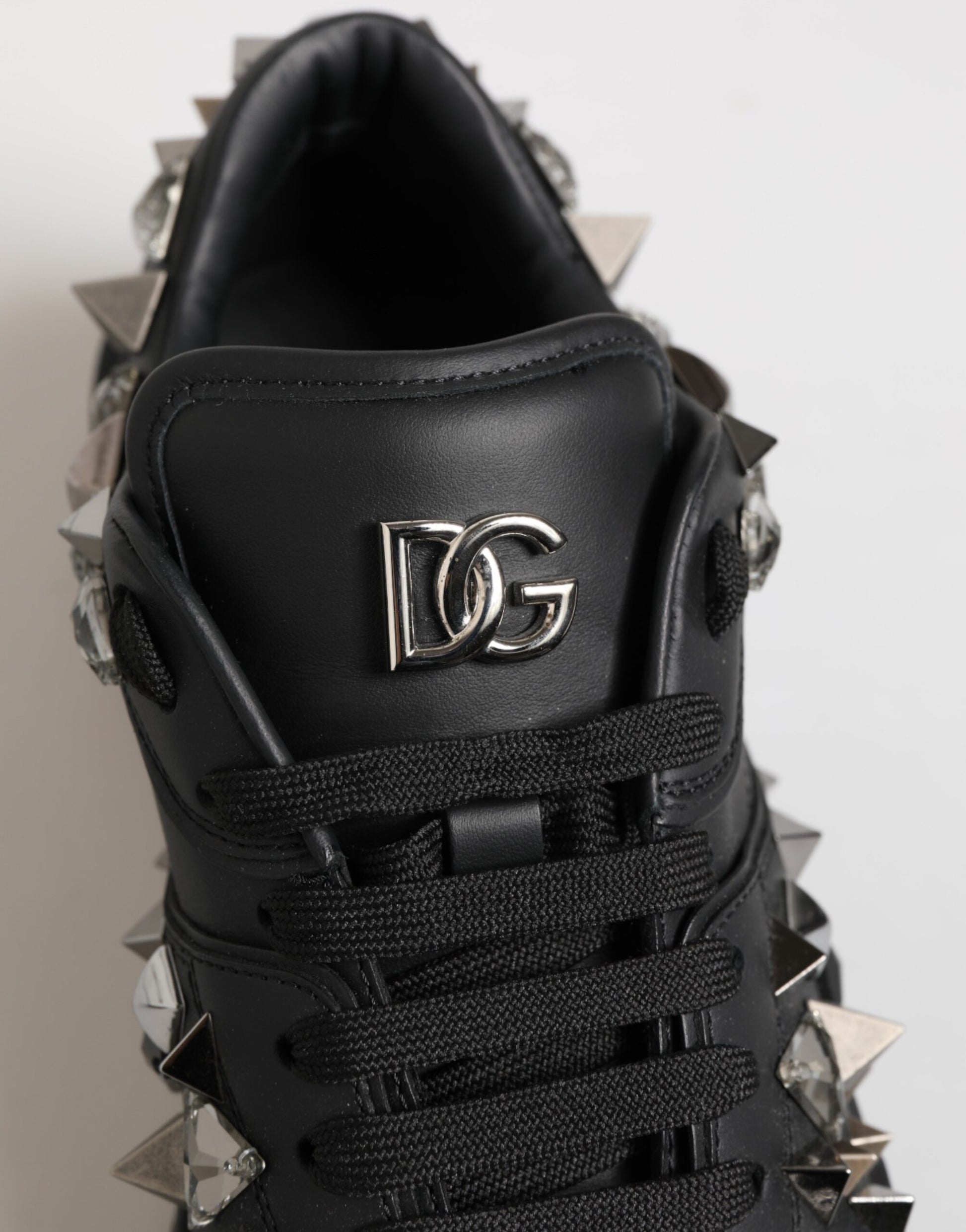 Black studded men's sneakers with D&G logo, featuring spiky details and a chunky sole