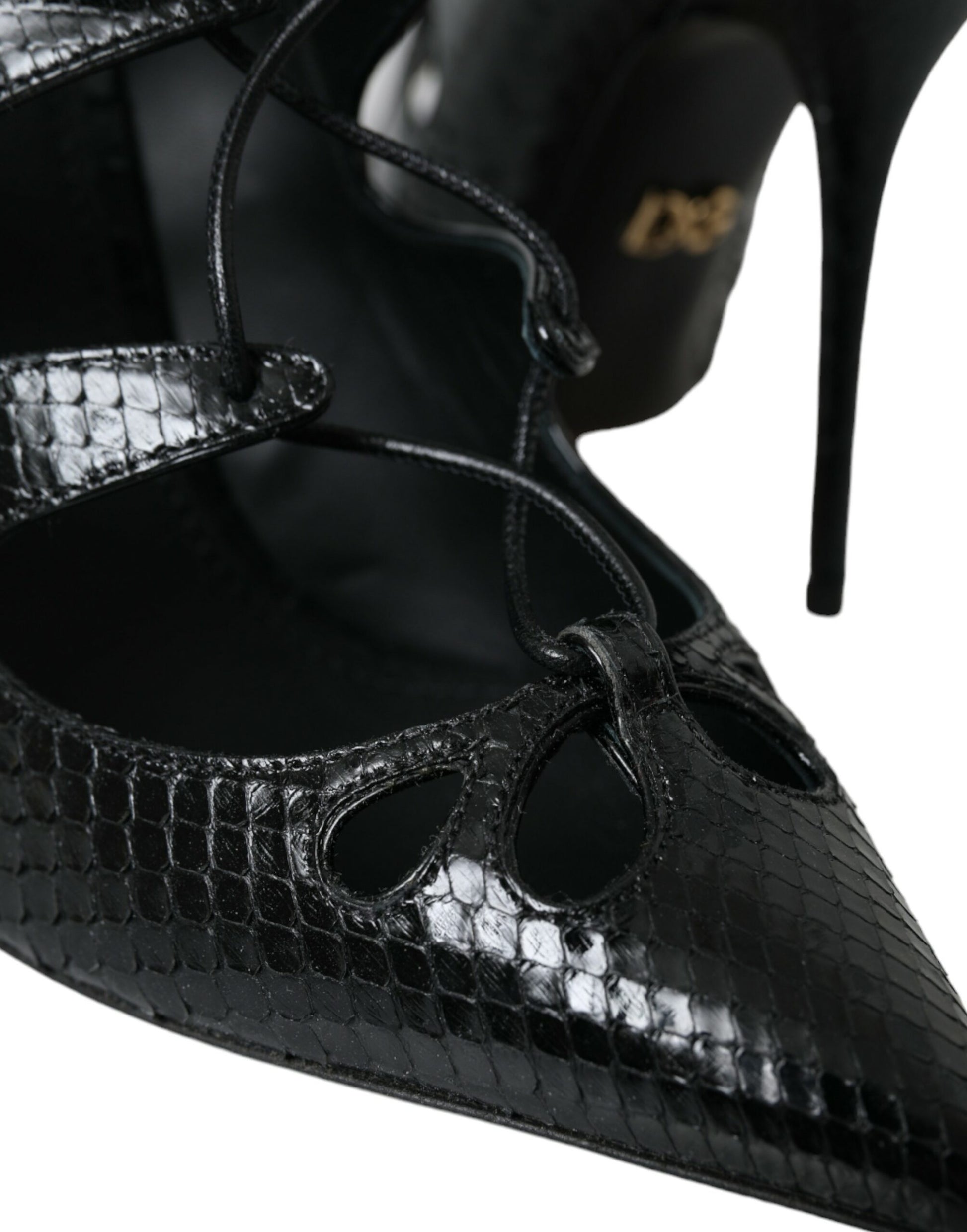 Black high heel shoes with a snake skin texture and a bow on top