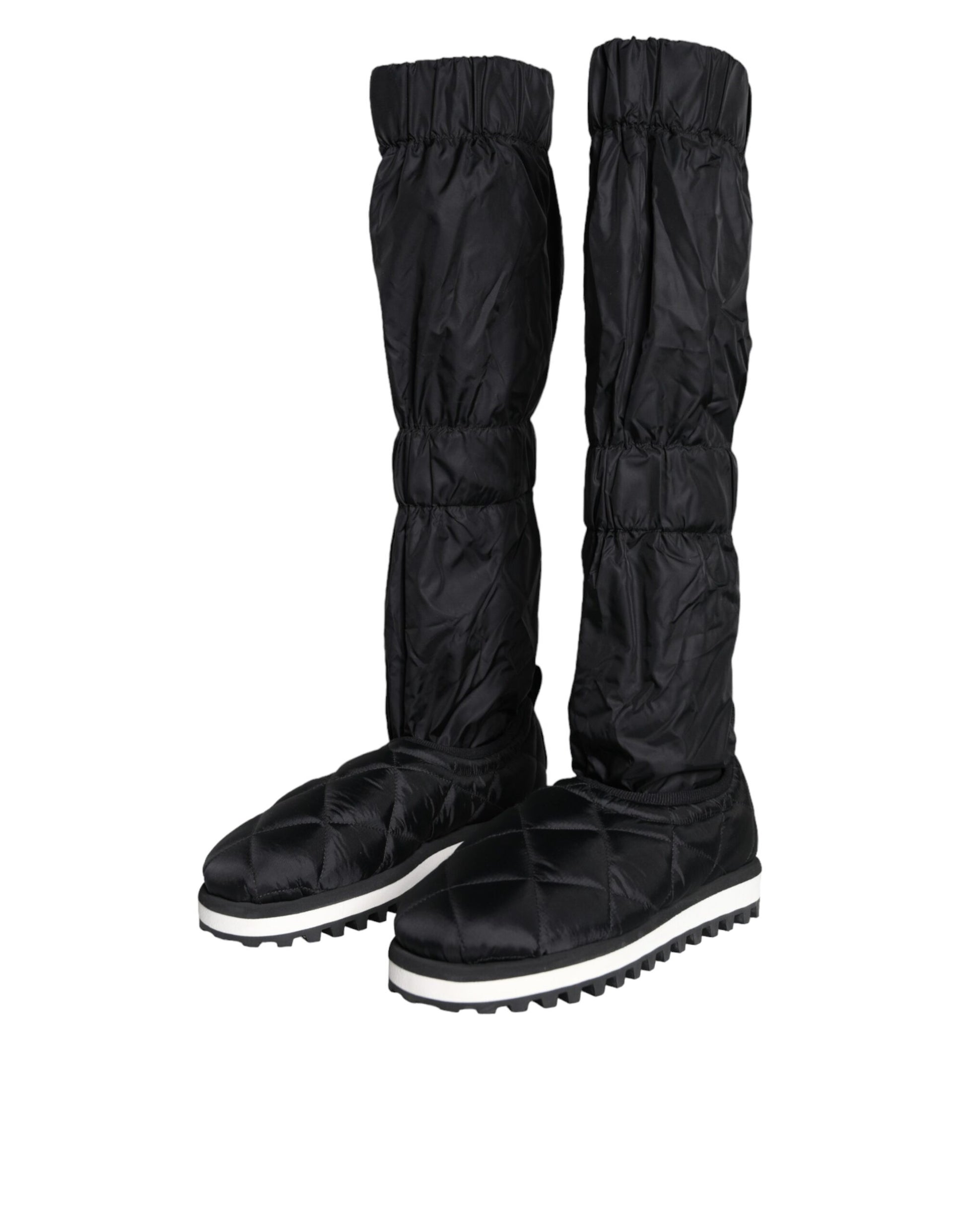 Pair of black rain boots with white soles and laces