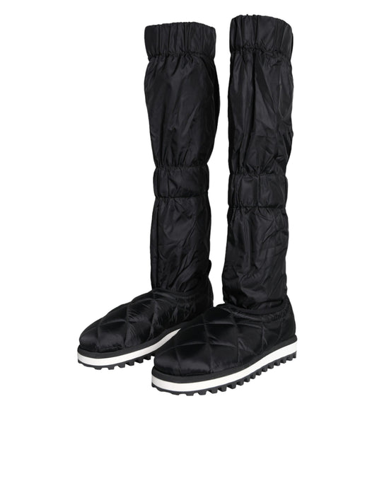 Pair of black rain boots with white soles and laces