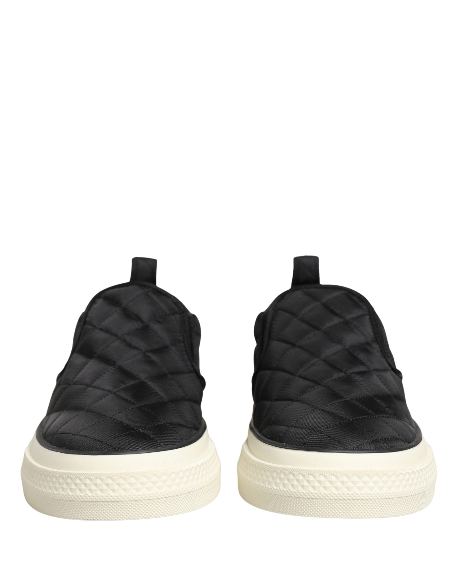Pair of black quilted slip-on shoes with white soles