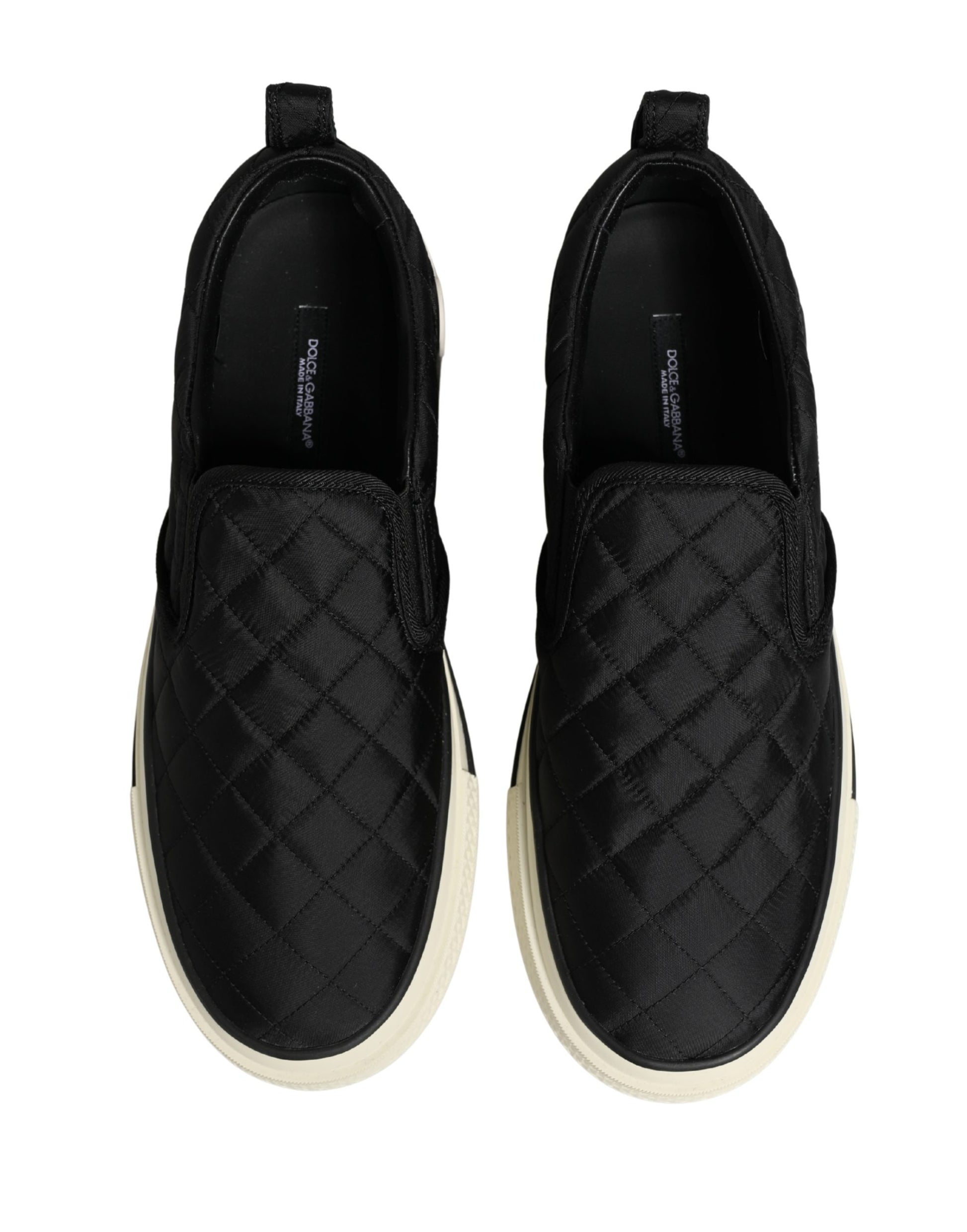 Pair of black quilted slip-on shoes with tan soles