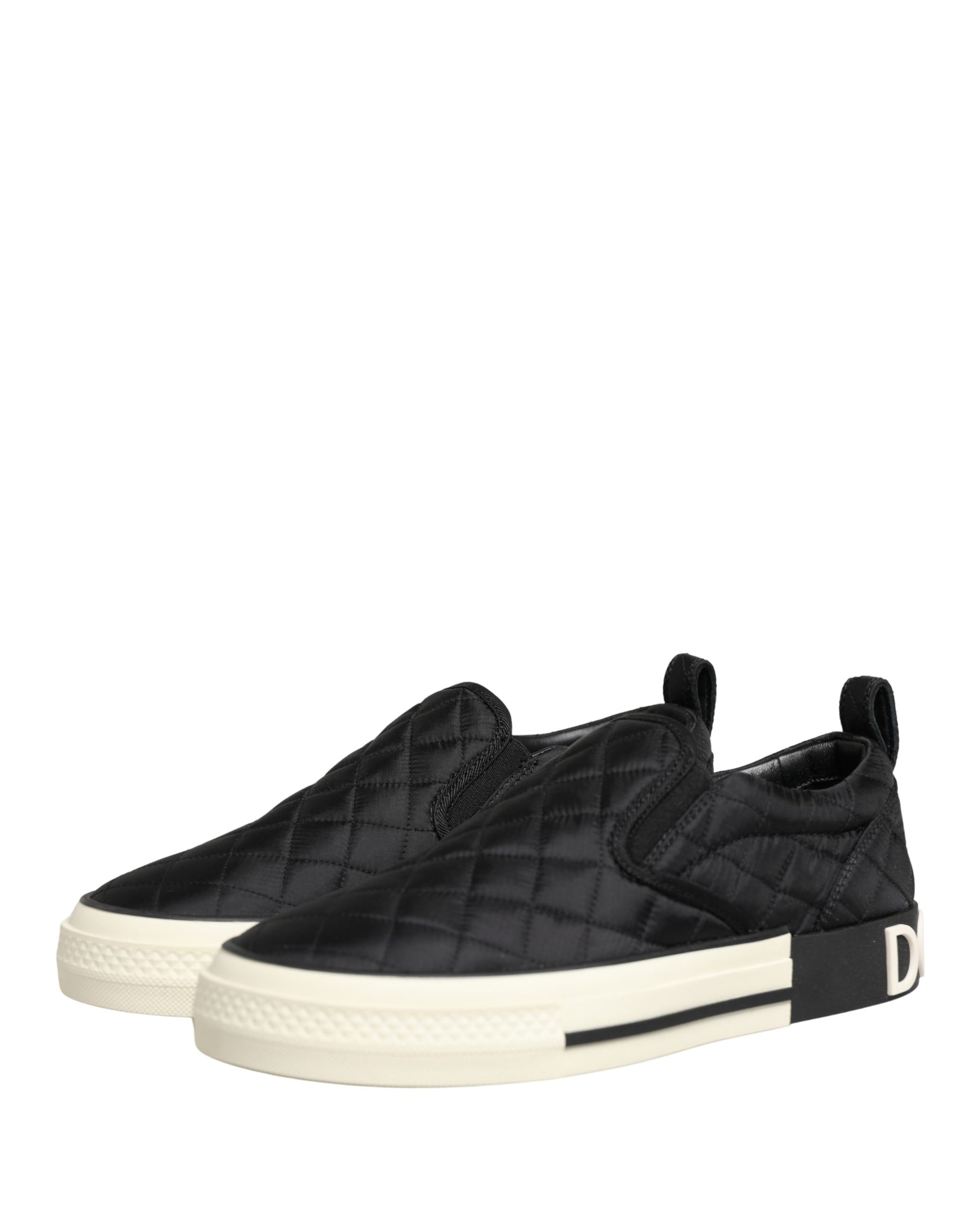 Pair of black quilted slip-on shoes with white soles