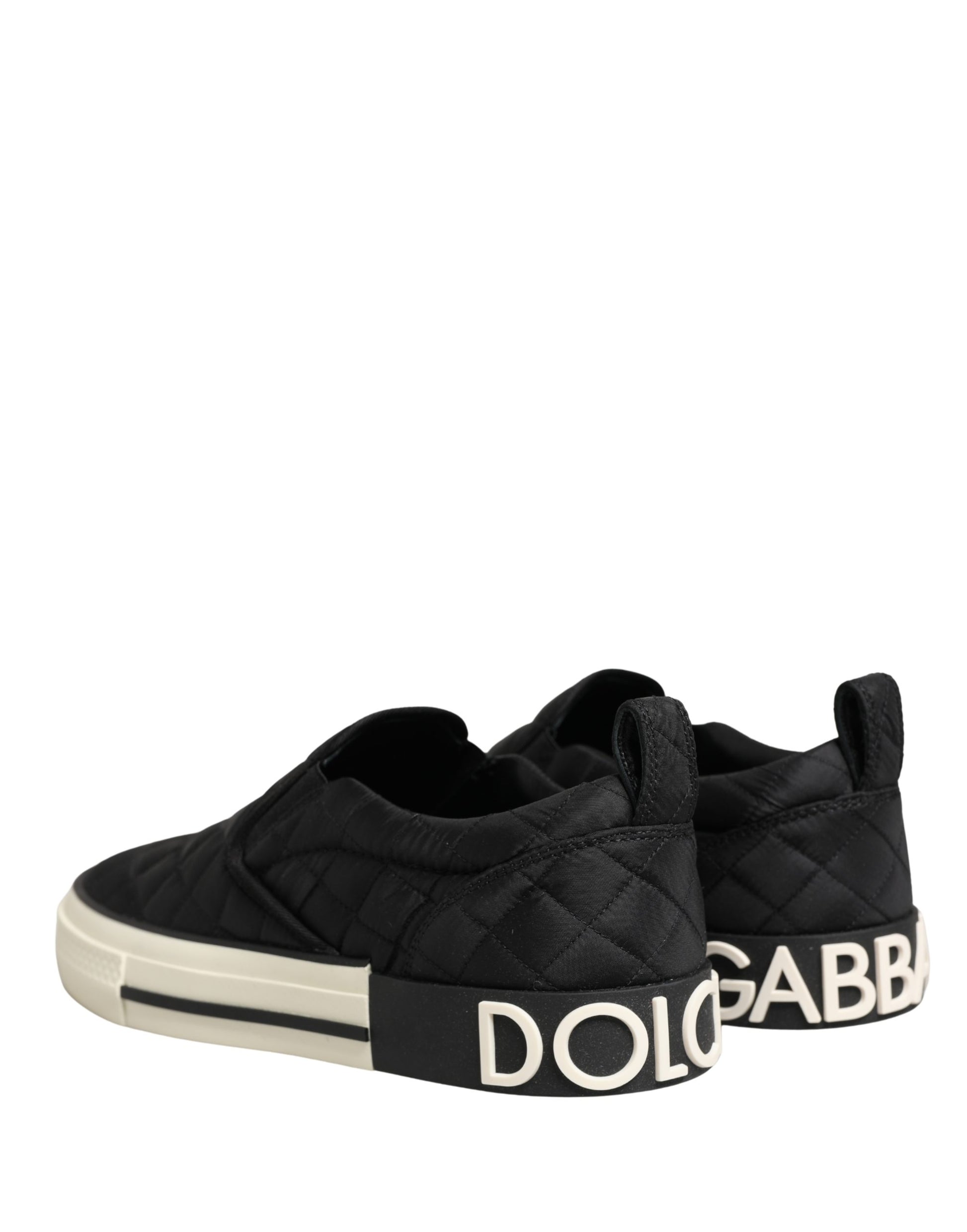 Black quilted slip-on shoes with white soles, featuring the Dolce & Gabbana logo