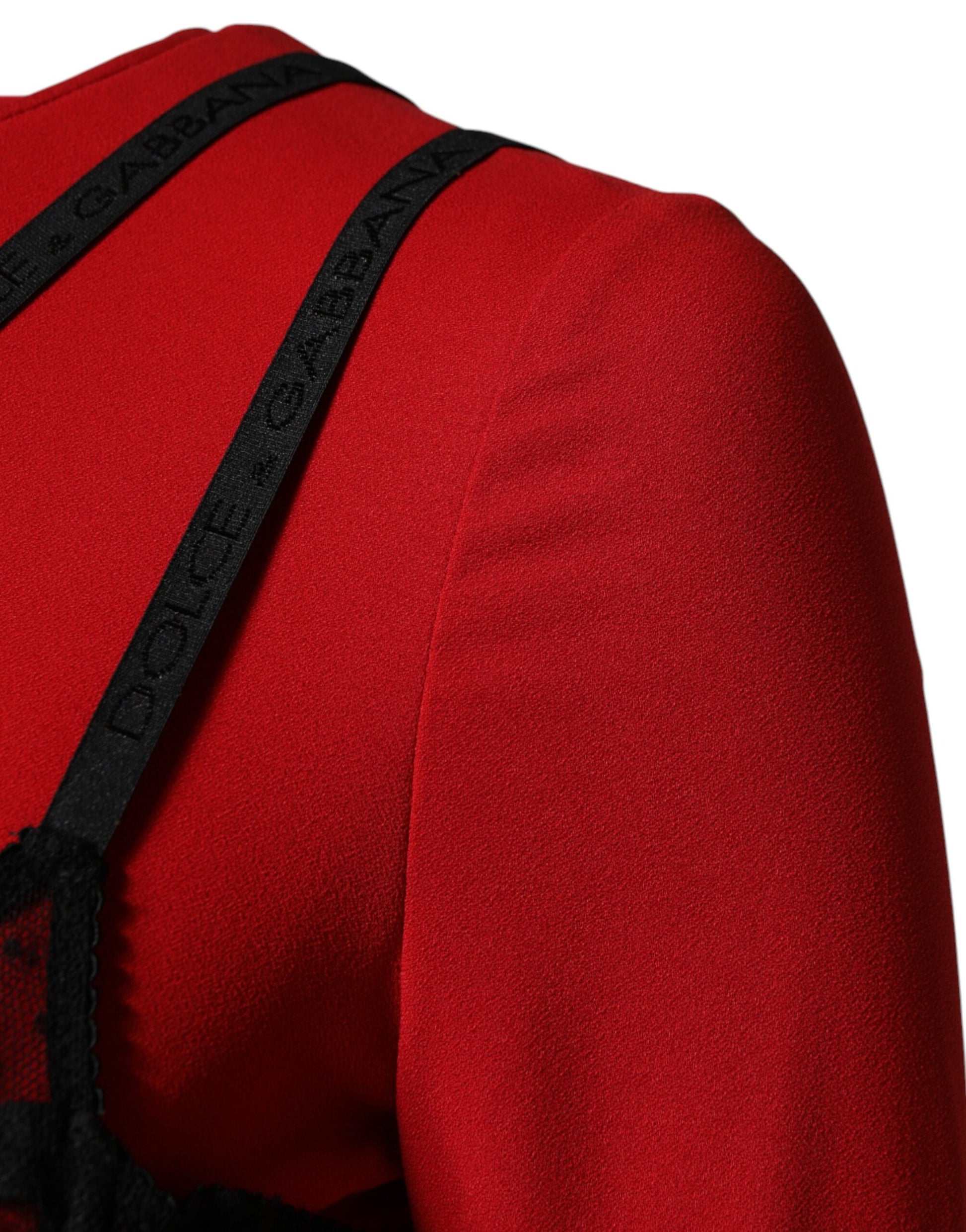 A red midi dress with black lace detailing on the shoulders and neckline
