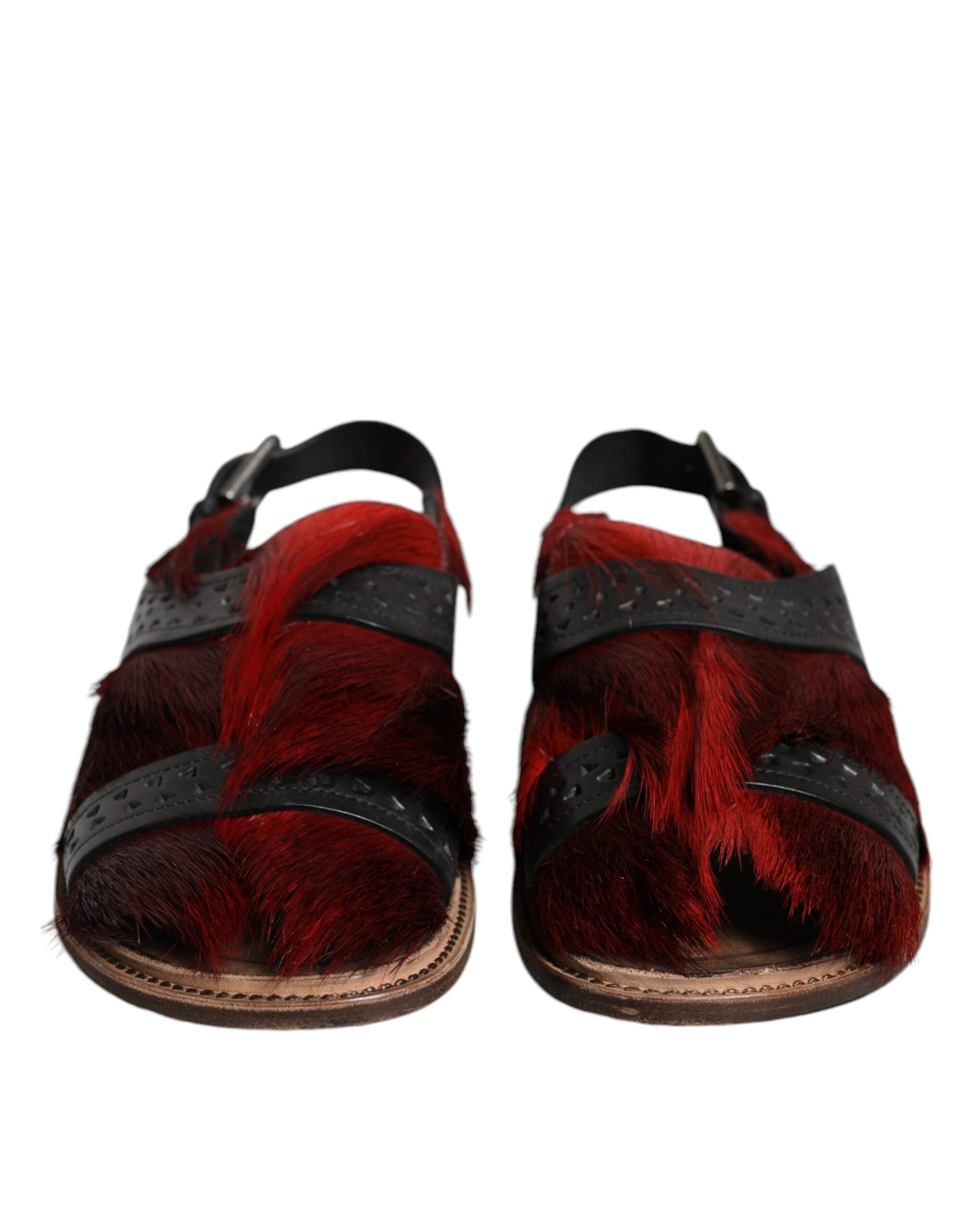 Pair of red furry sandals with black straps