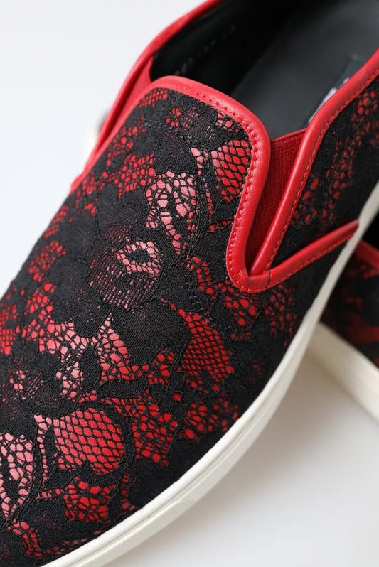 A pair of black red lace slip on low top shoes with a floral pattern