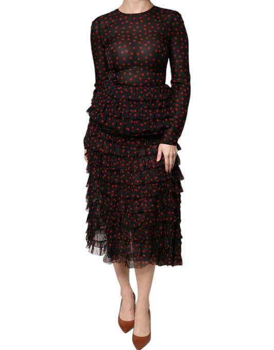 A black midi dress with red polka dots and layered silk skirt