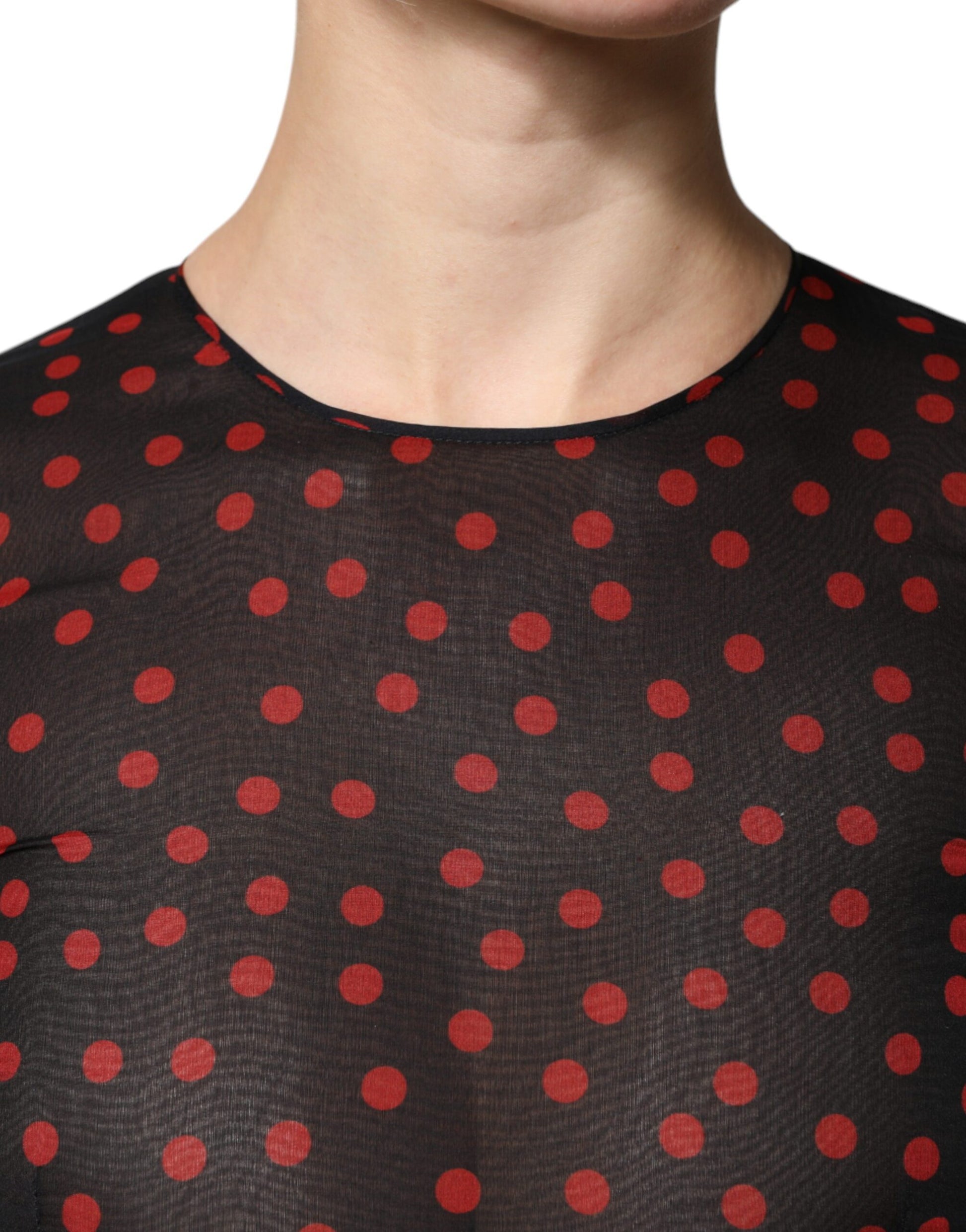 A black midi dress with red polka dots and a layered design