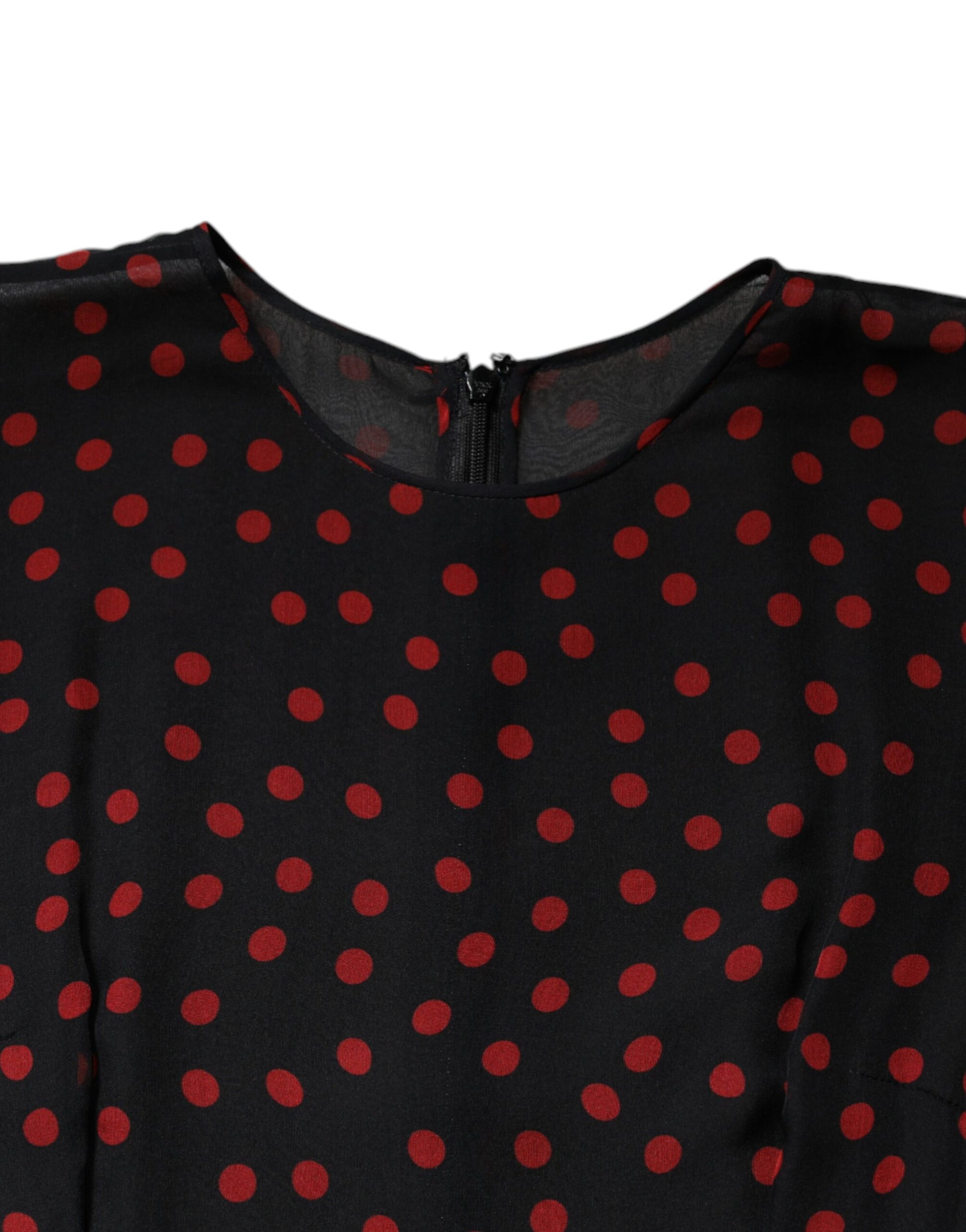 A black dress with red polka dots, featuring a layered design and silk material