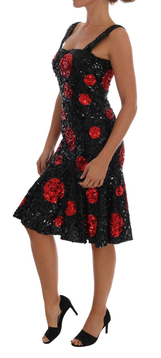 A black dress with red sequins and polka dots, worn by a model