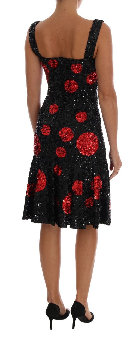 A black dress with red sequins and polka dots, worn by a mannequin