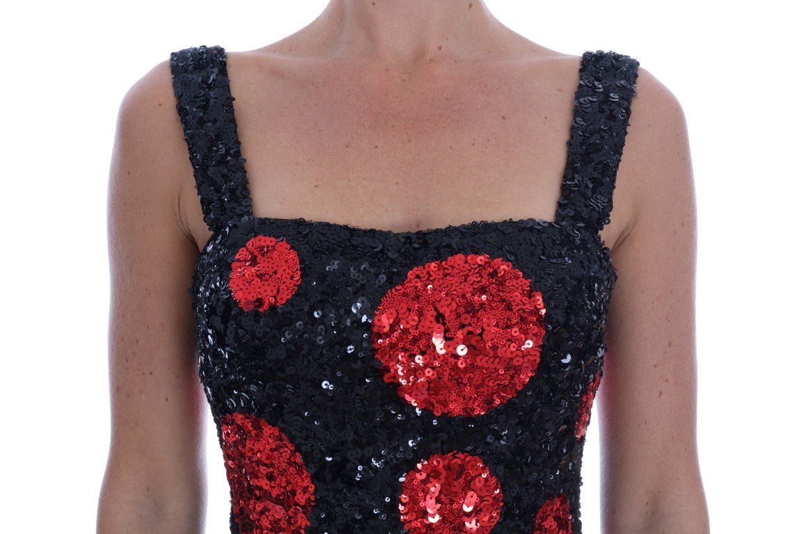 A black sequined dress with red polka dots and a shift silhouette