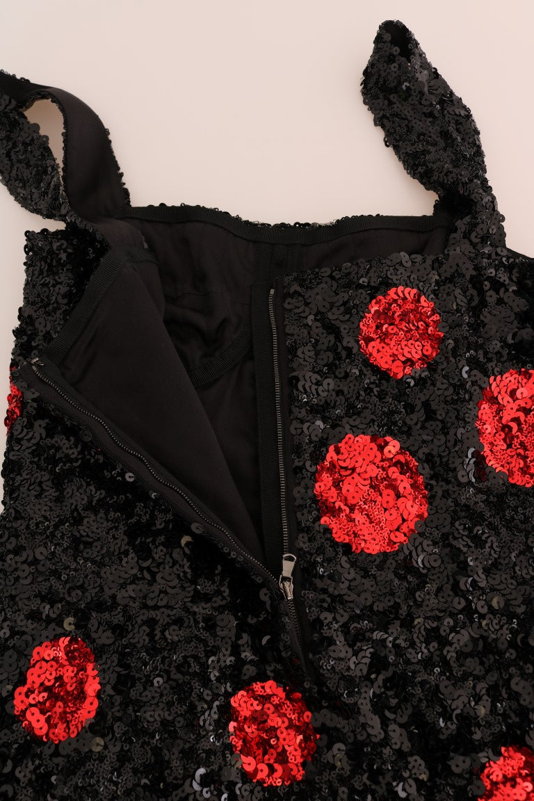 A black sequined dress with red polka dots and a shift style, featuring a V-neckline