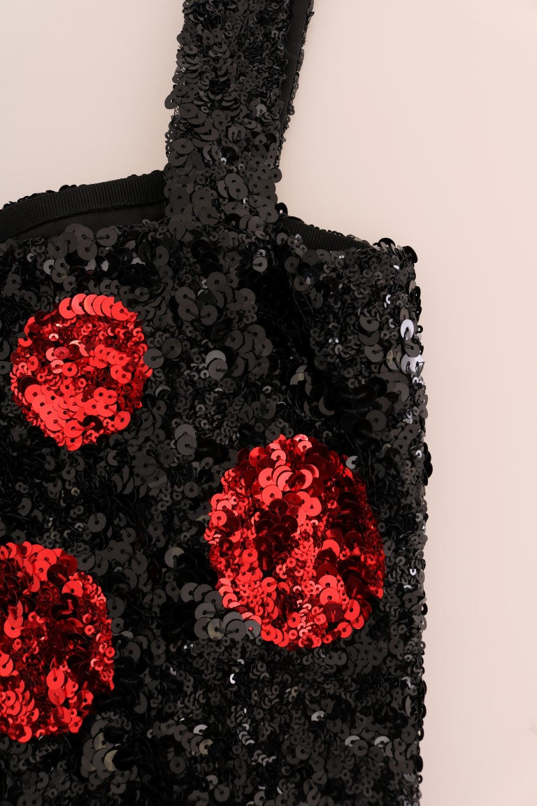 A black sequined dress with red polka dots and a shift silhouette