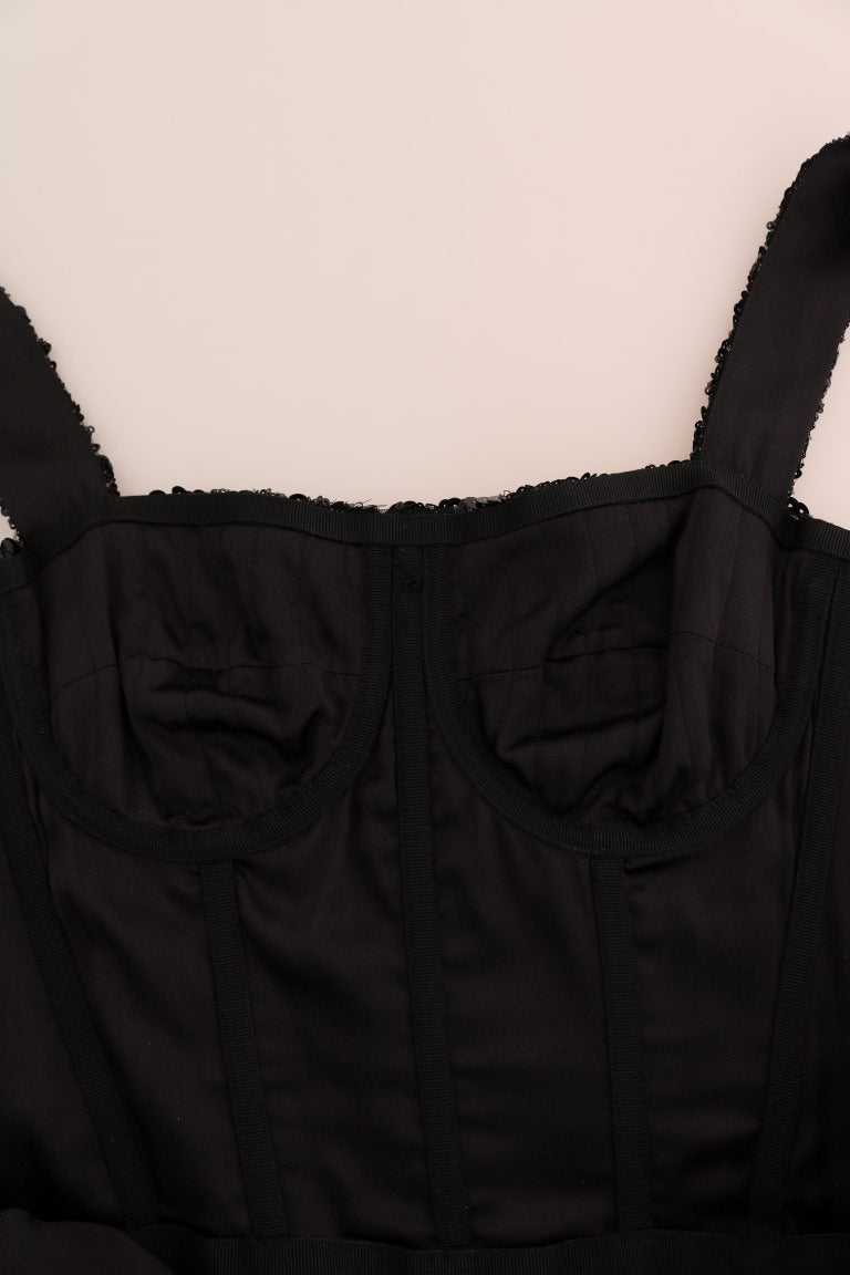 A black sequined dress with red polka dots and a shift style, featuring lace trim