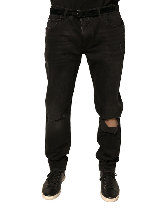 Black denim jeans with distressed areas on legs