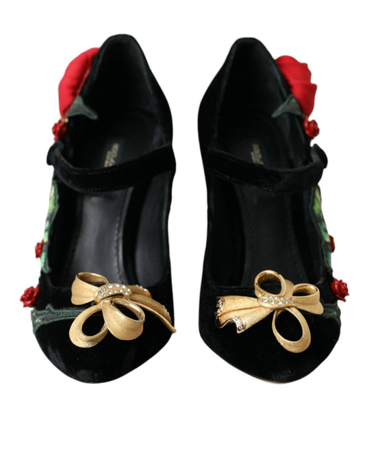 Pair of black shoes with gold bows and red flowers on top