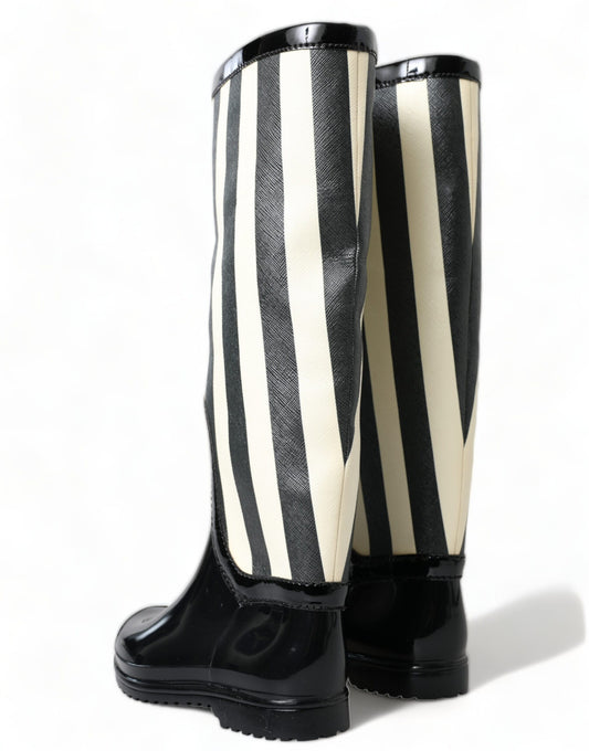 Pair of black and white striped rain boots with a shiny finish