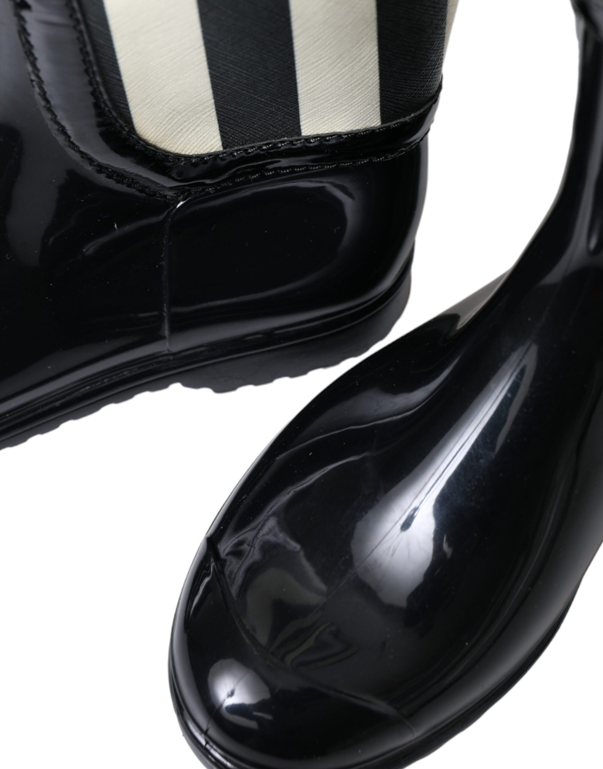 Pair of black patent leather shoes with white stripes on sides and heels