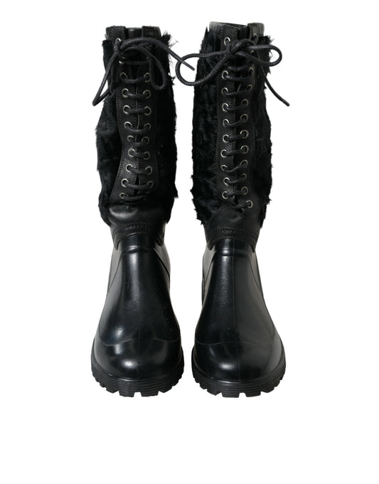 Pair of black leather boots with laces and fur trim around top