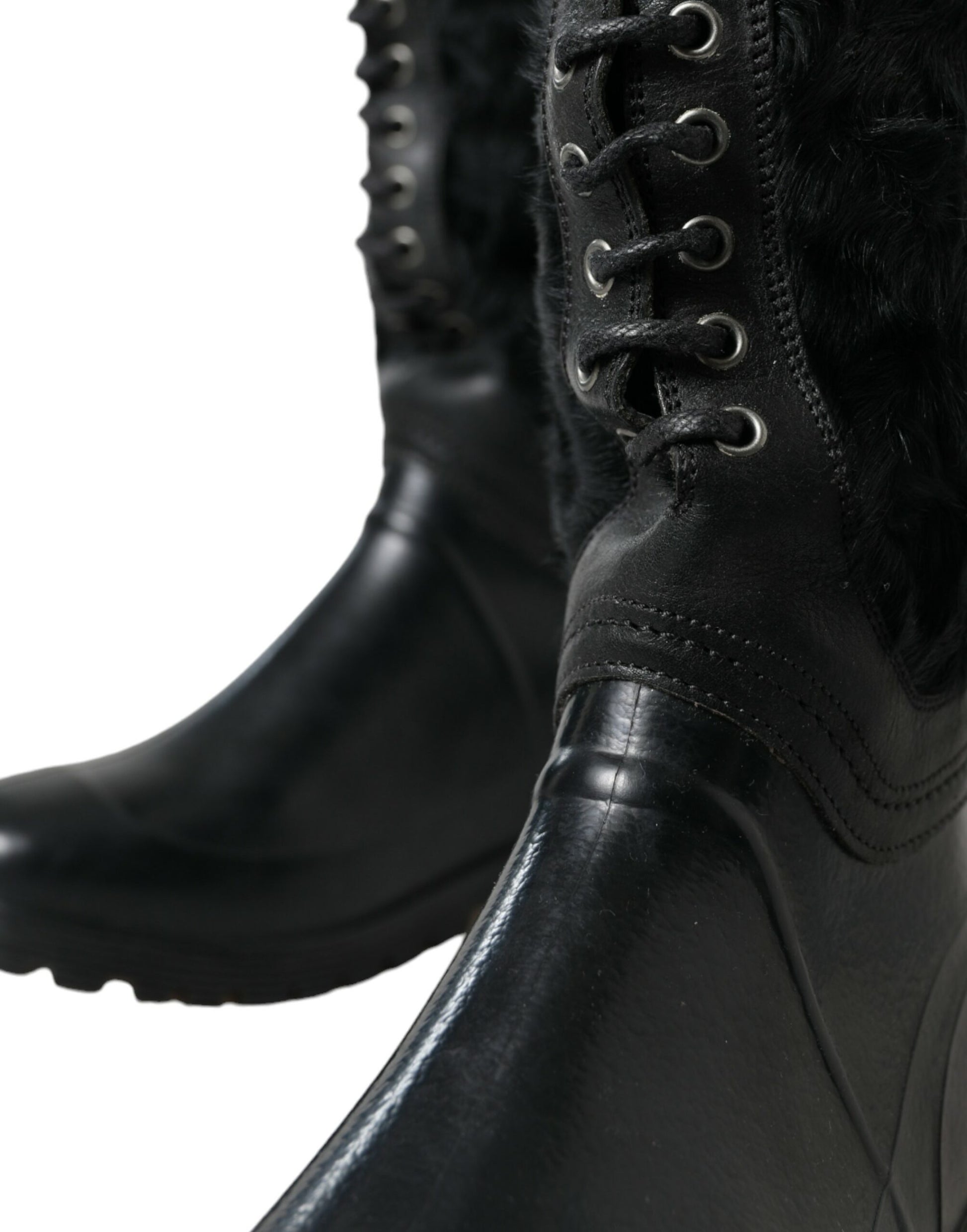 Pair of black leather boots with fur trim and laces