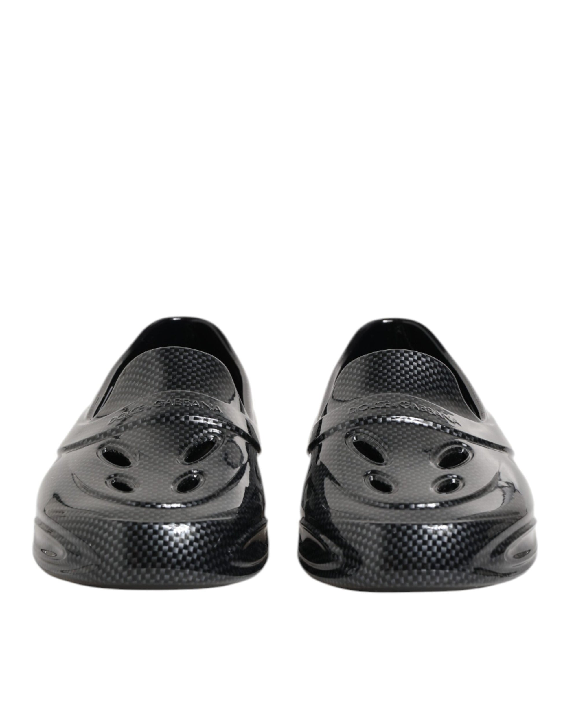Pair of black shoes with holes in the top for ventilation