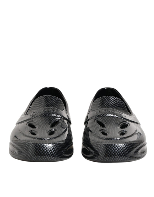 Pair of black shoes with holes in the top for ventilation