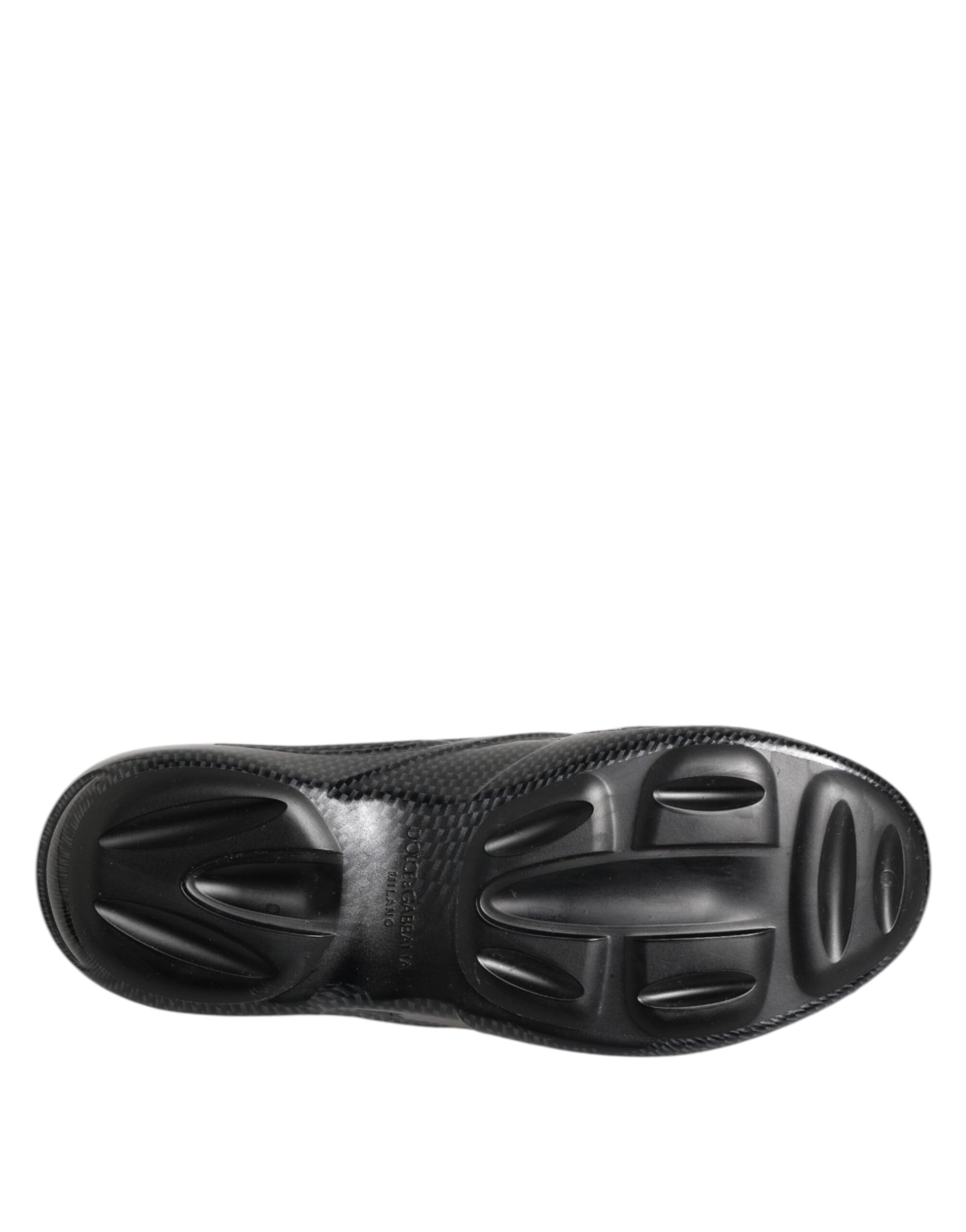 Black shoe with cleats on bottom