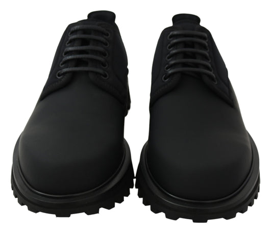 Pair of black leather shoes with laces and rubber soles