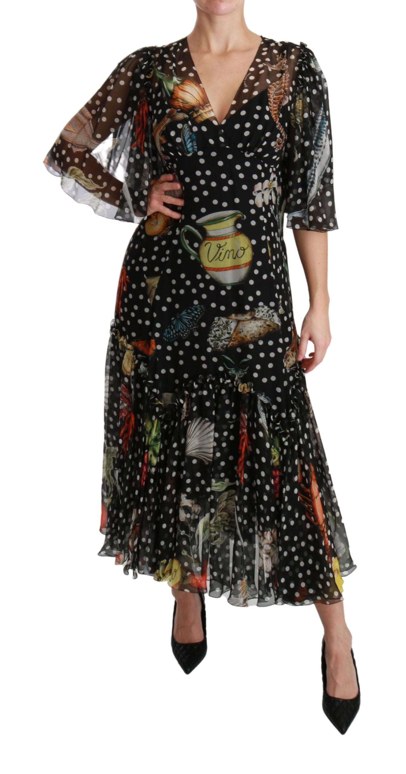 A black dress with a sea fish print, featuring a high neck and long sleeves