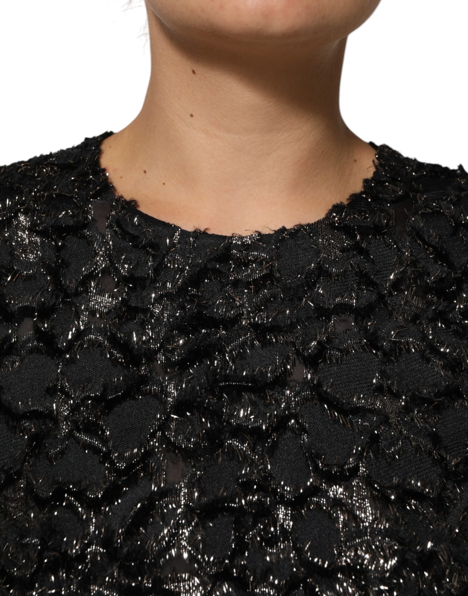 A black sequin bouclé tweed sheath dress with a V-neckline