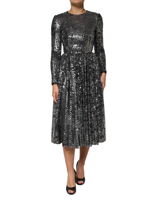 A black sequined midi dress with long sleeves and an A-line skirt