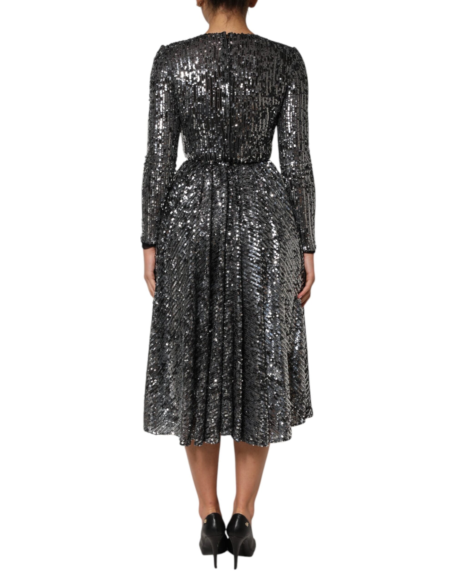 A black sequined midi dress with long sleeves and an A-line skirt