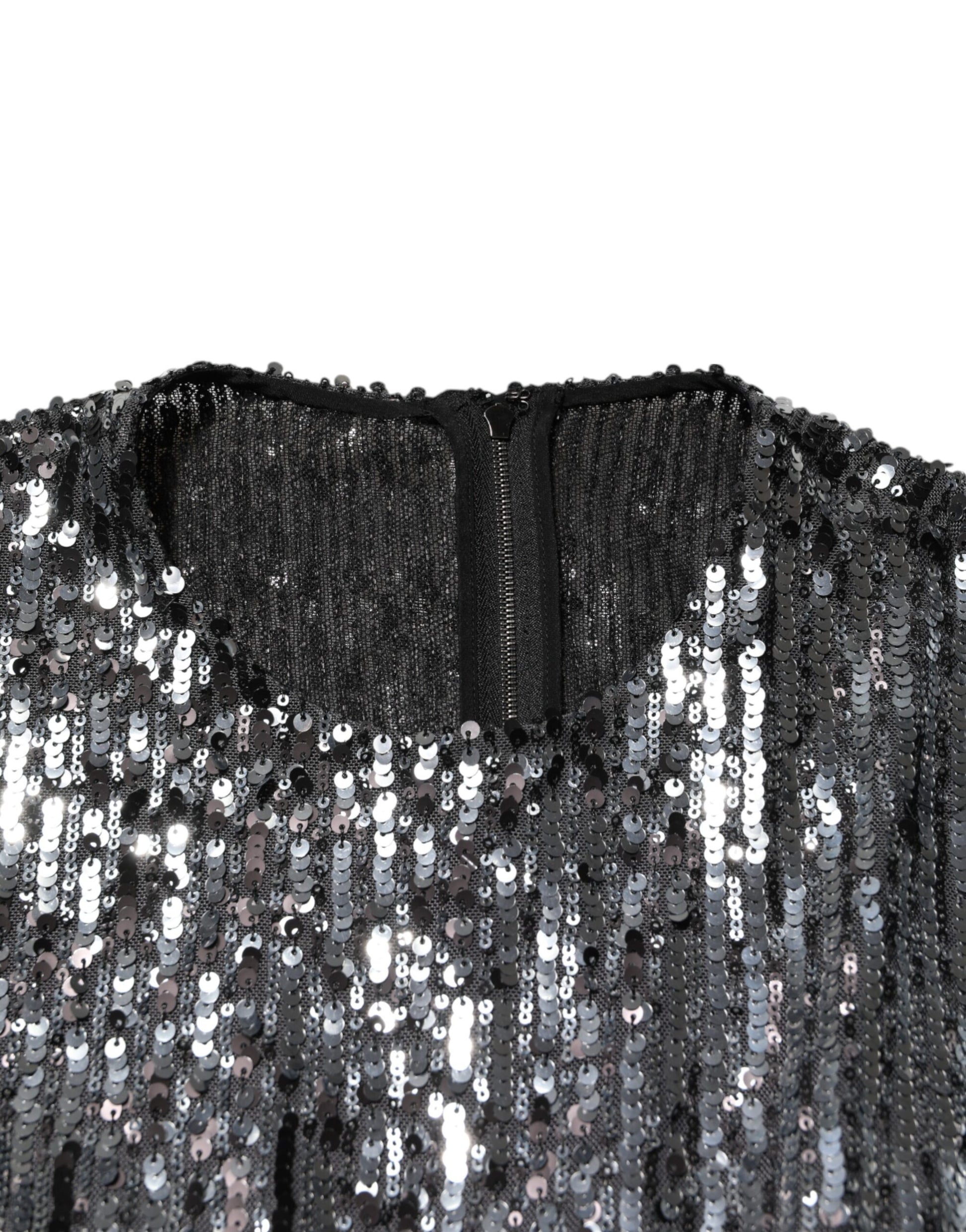A black sequined midi dress with long sleeves. It features an A-line silhouette and is designed by Dolce & Ga