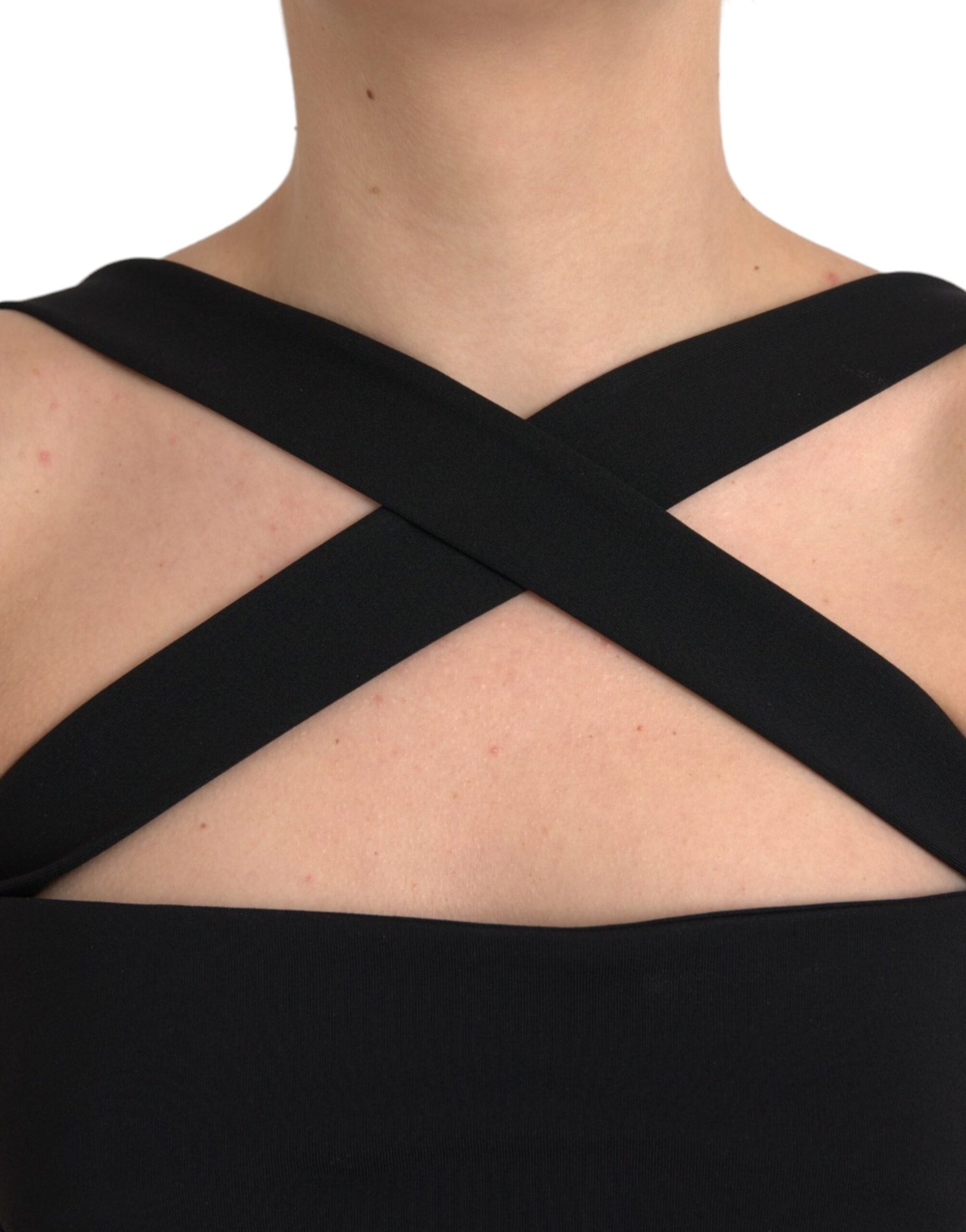 A black halter neck sheath dress with a midi length and sleeveless design