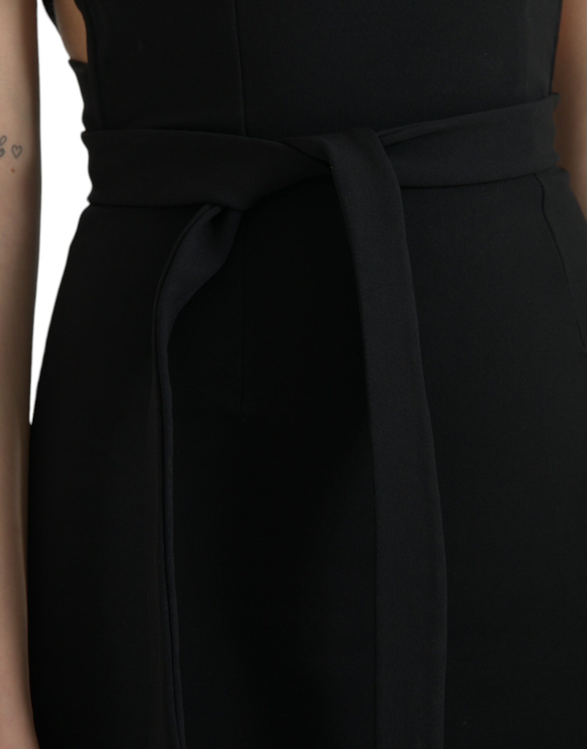 A black sheath halter sleeveless midi dress with a belted waist