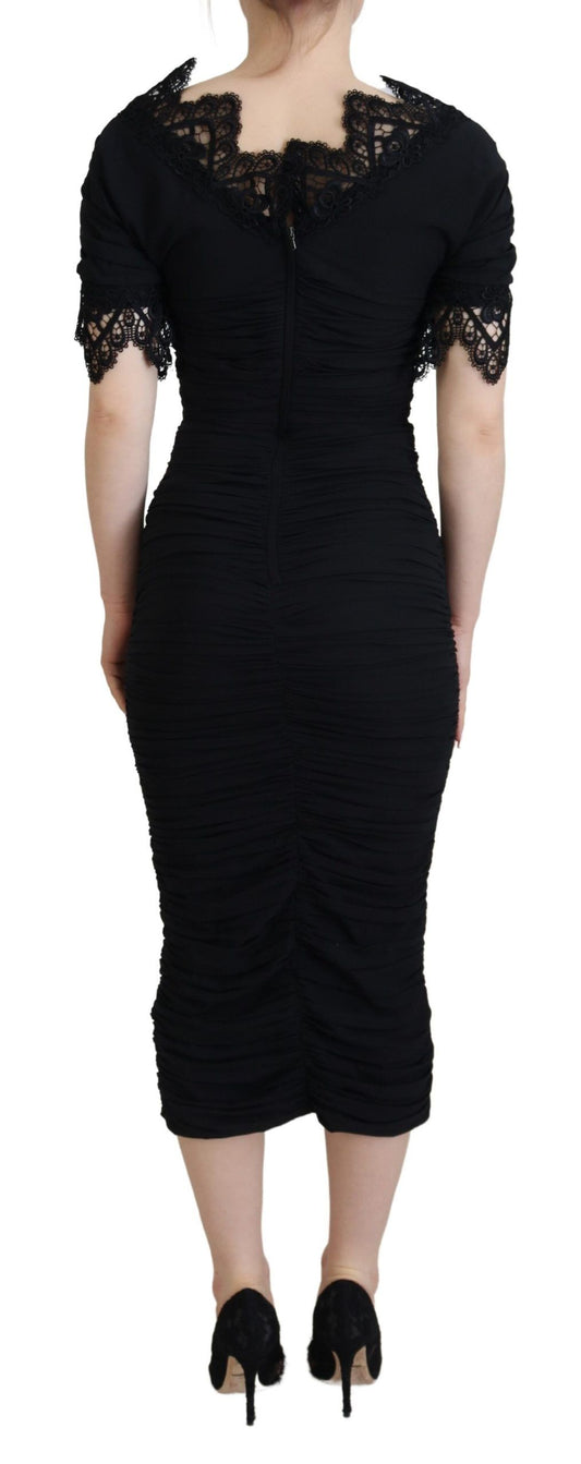 A black sheath midi dress with lace and silk details, featuring a body-skimming design