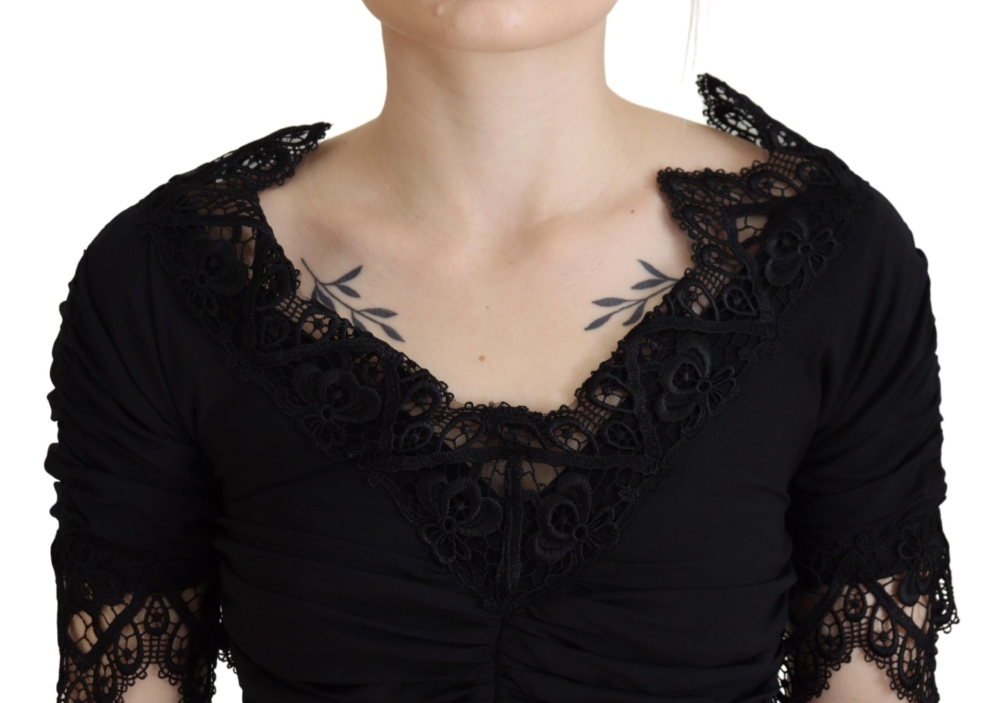 A black lace midi dress with sheer sleeves and a body-skimming silhouette