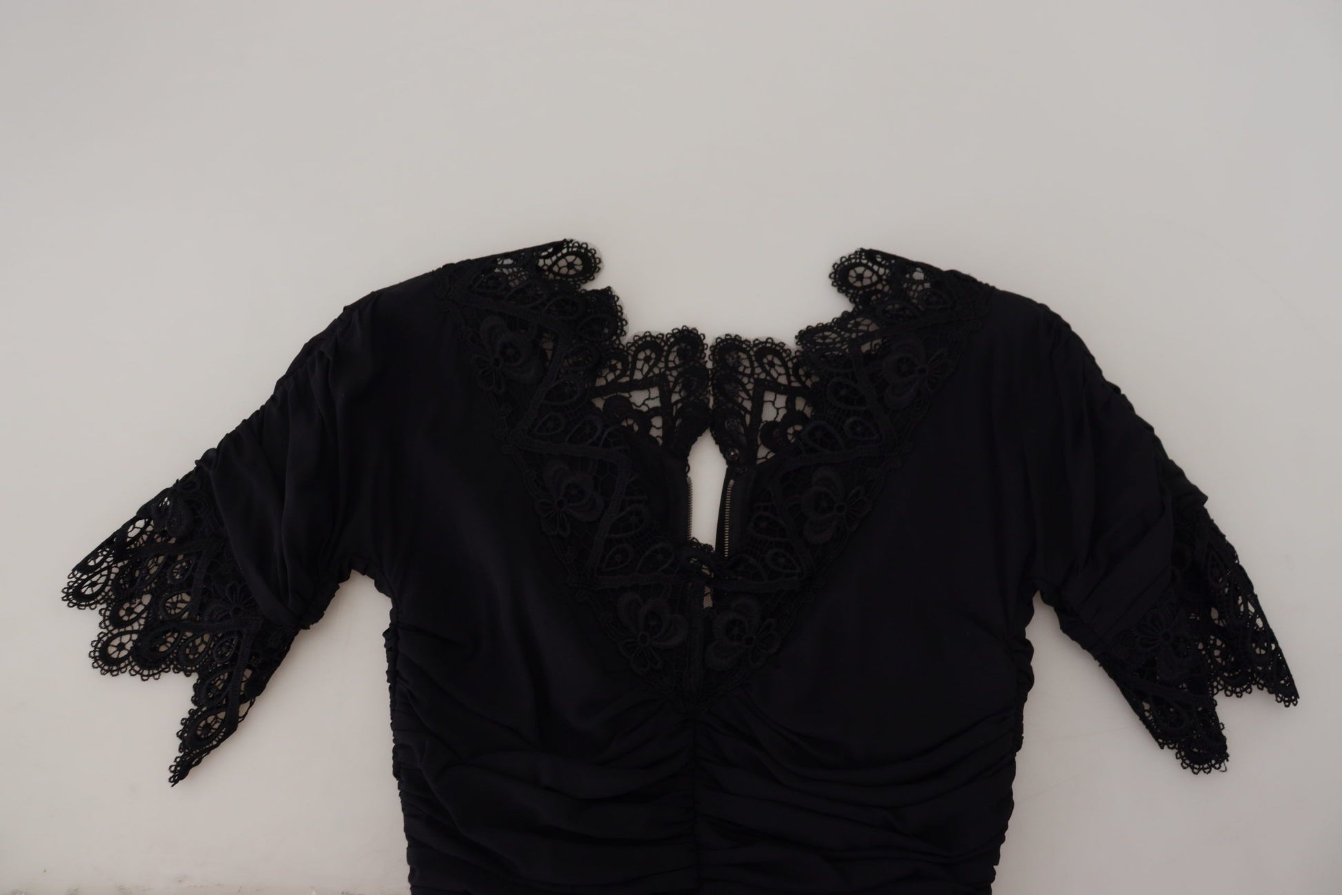 A black lace sheath midi dress with a body-skimming silhouette