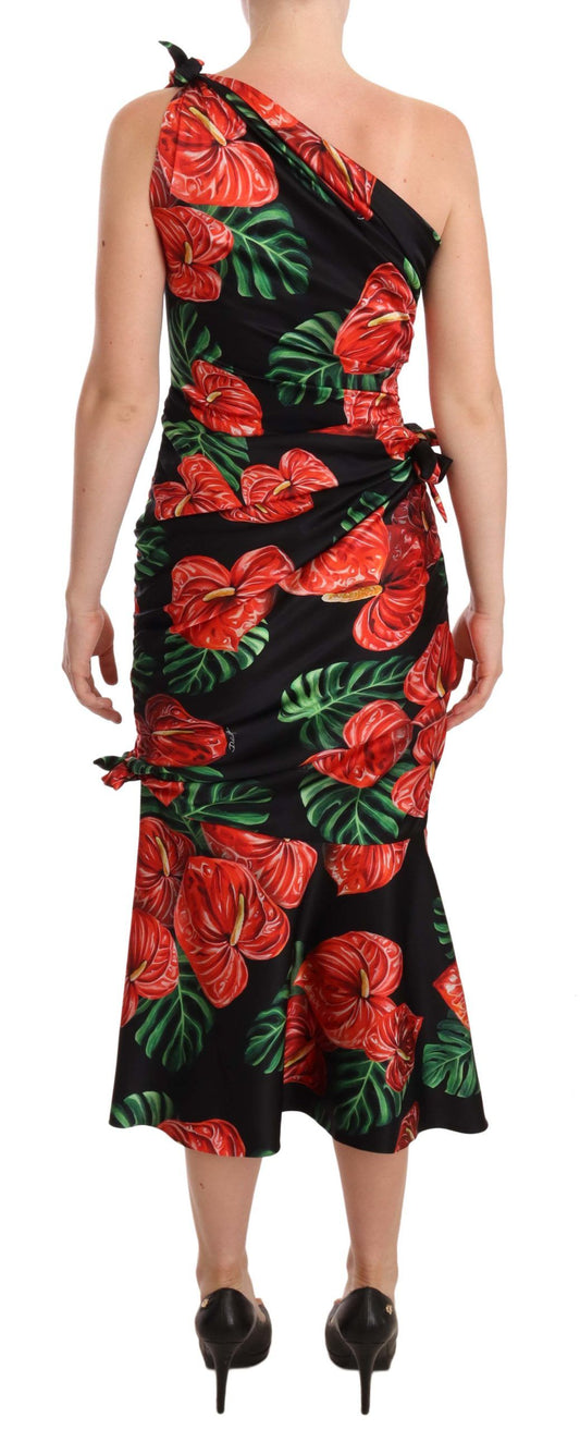 A black silk dress with a floral print and draped design, featuring a sleeveless style