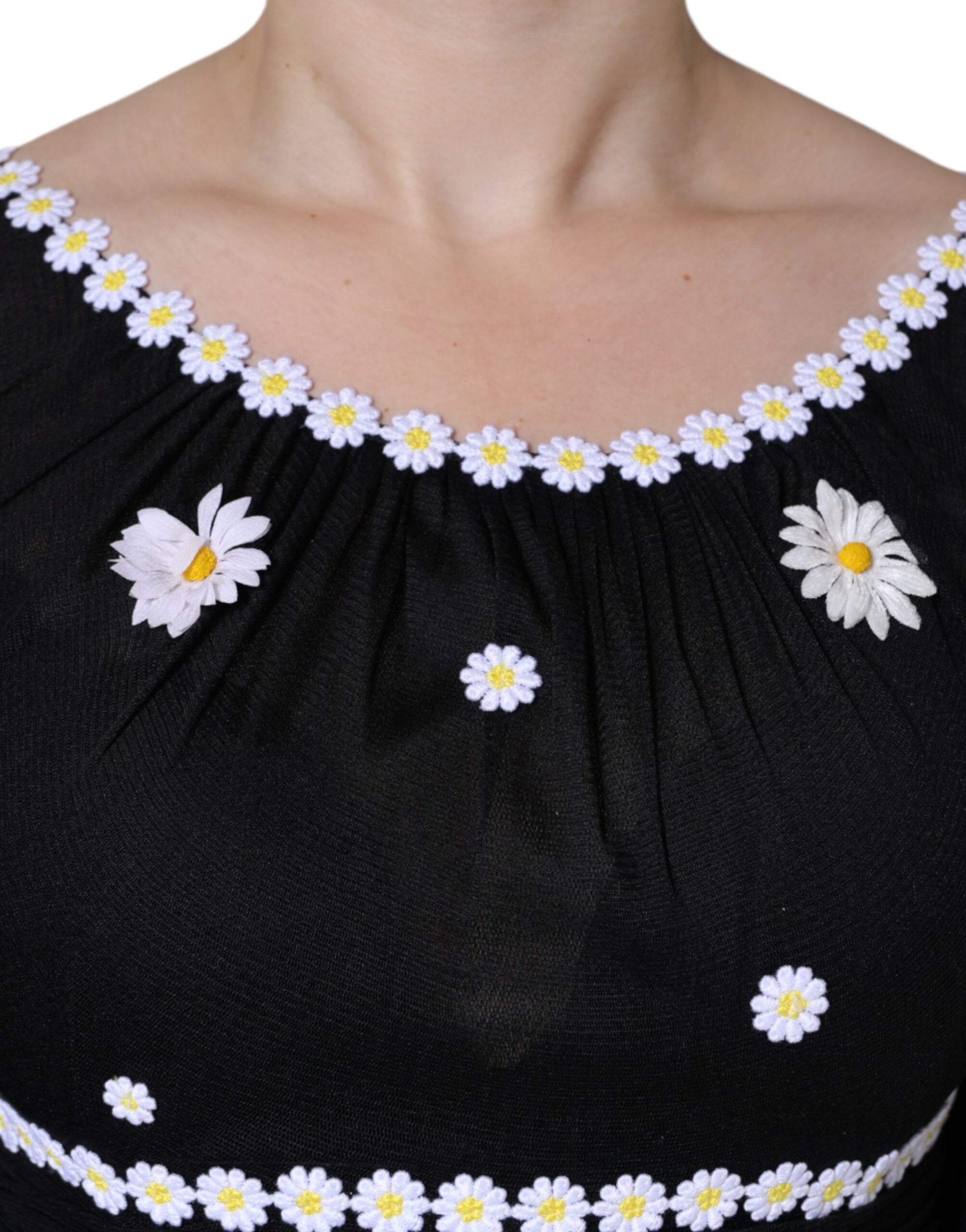 Black silk dress with daisy embellishments on neckline and sleeves