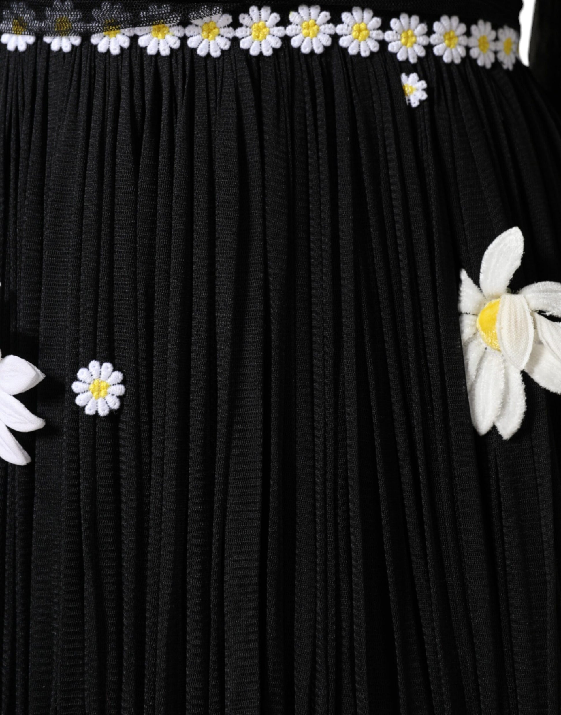 Black silk dress with daisy embellishments and a long skirt