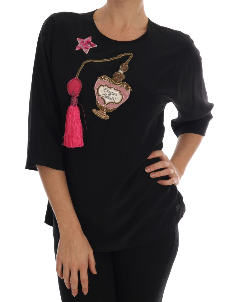 Black long sleeve shirt with pink tassel on left shoulder