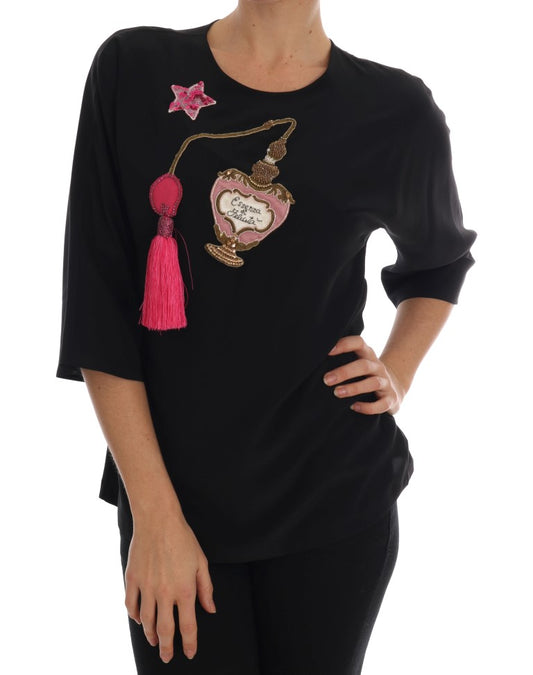 Black long sleeve shirt with pink tassel on left shoulder