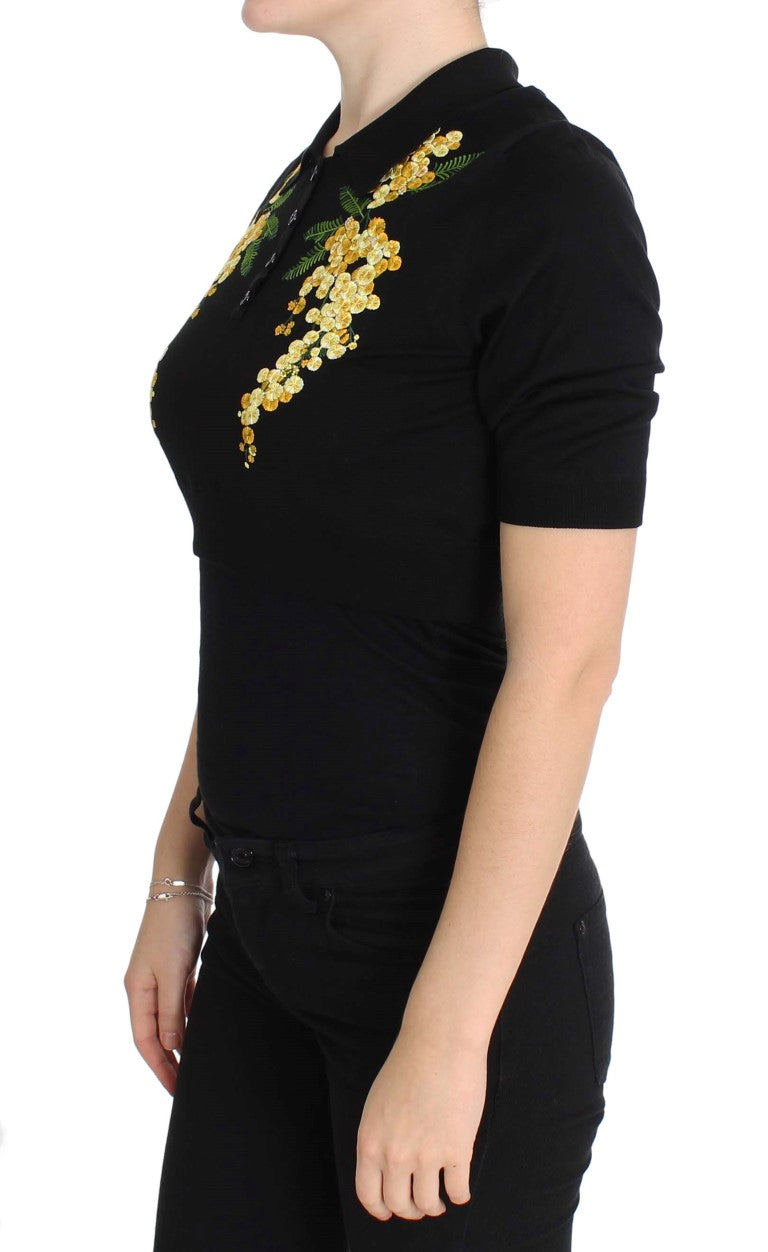 Black shirt with yellow embroidery on woman's torso