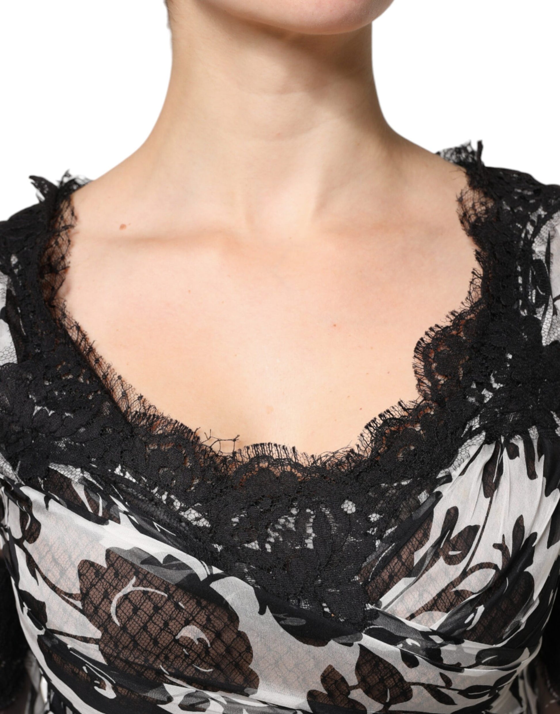 A black lace dress with floral patterns and ricamo detailing on the bodice