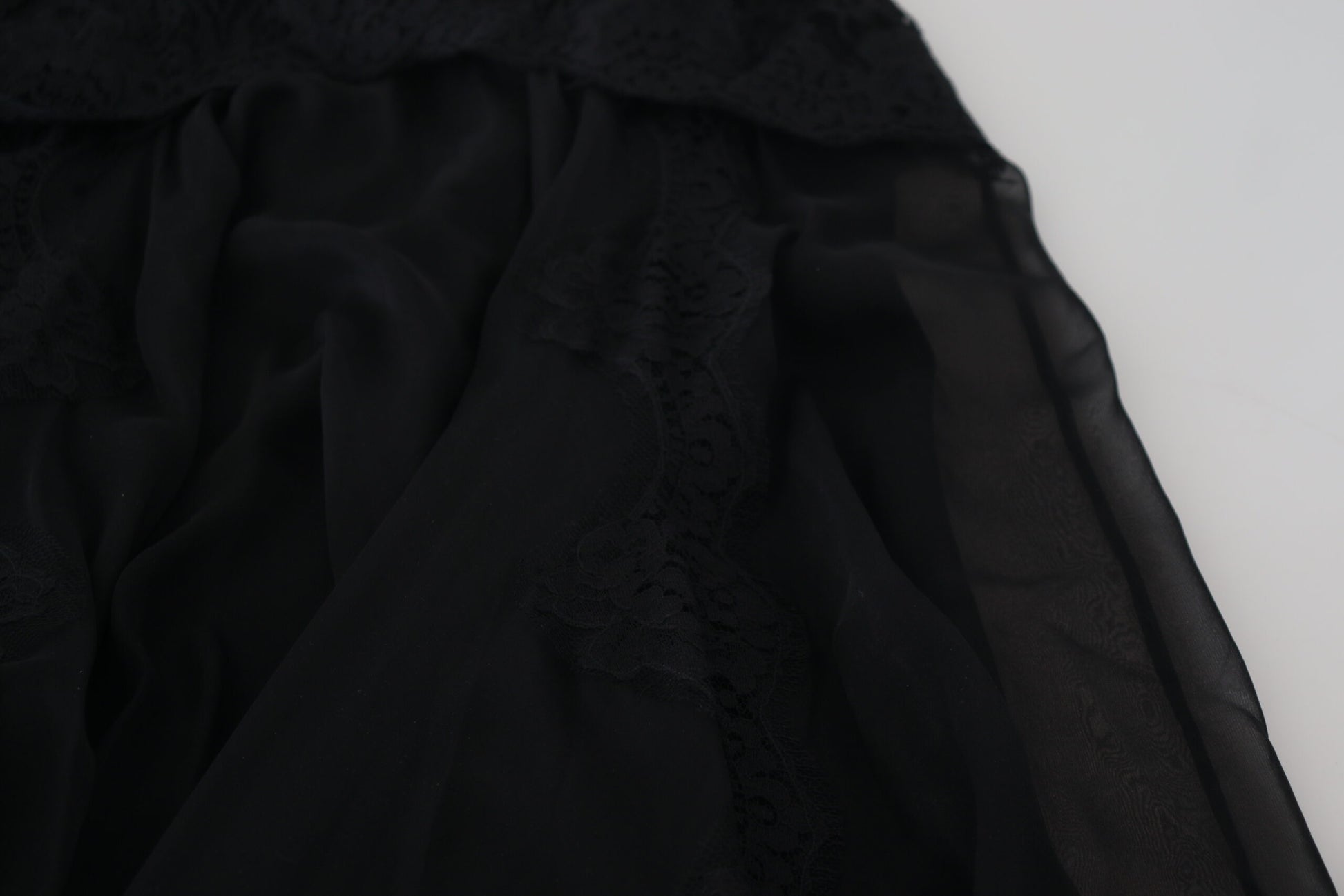 Black lace fabric on white background