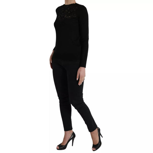 Woman wearing black top and pants, standing on one leg