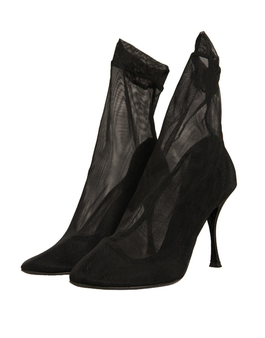 Pair of black high heel shoes with sheer stockings
